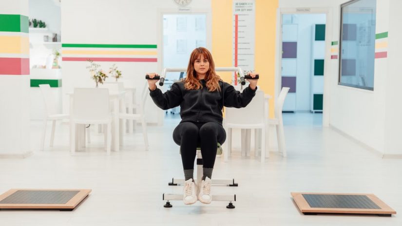 A woman exercises in a bright rehabilitation center, focusing on recovery and wellness.